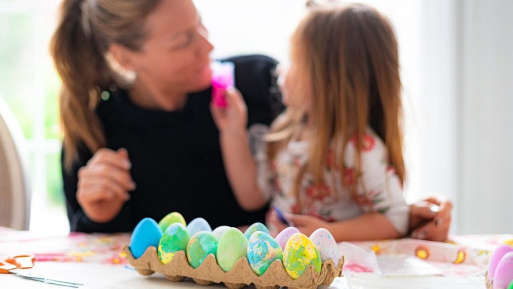 Family. Mom and daughter decorating eggs